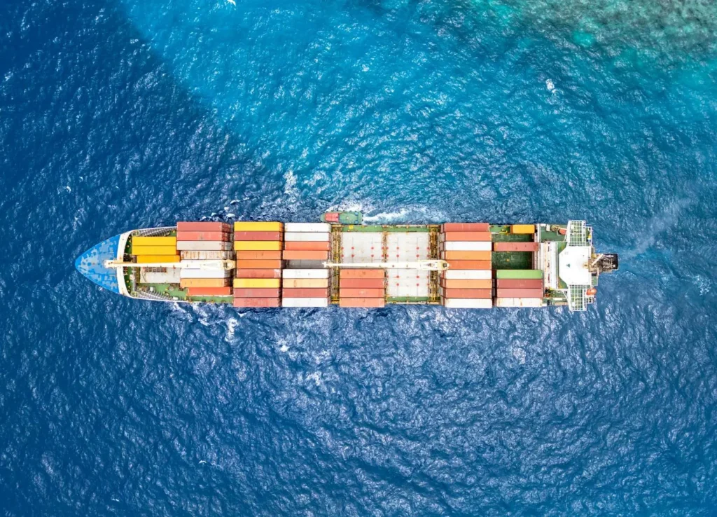 A laden container ship under way at sea, seen from directly above